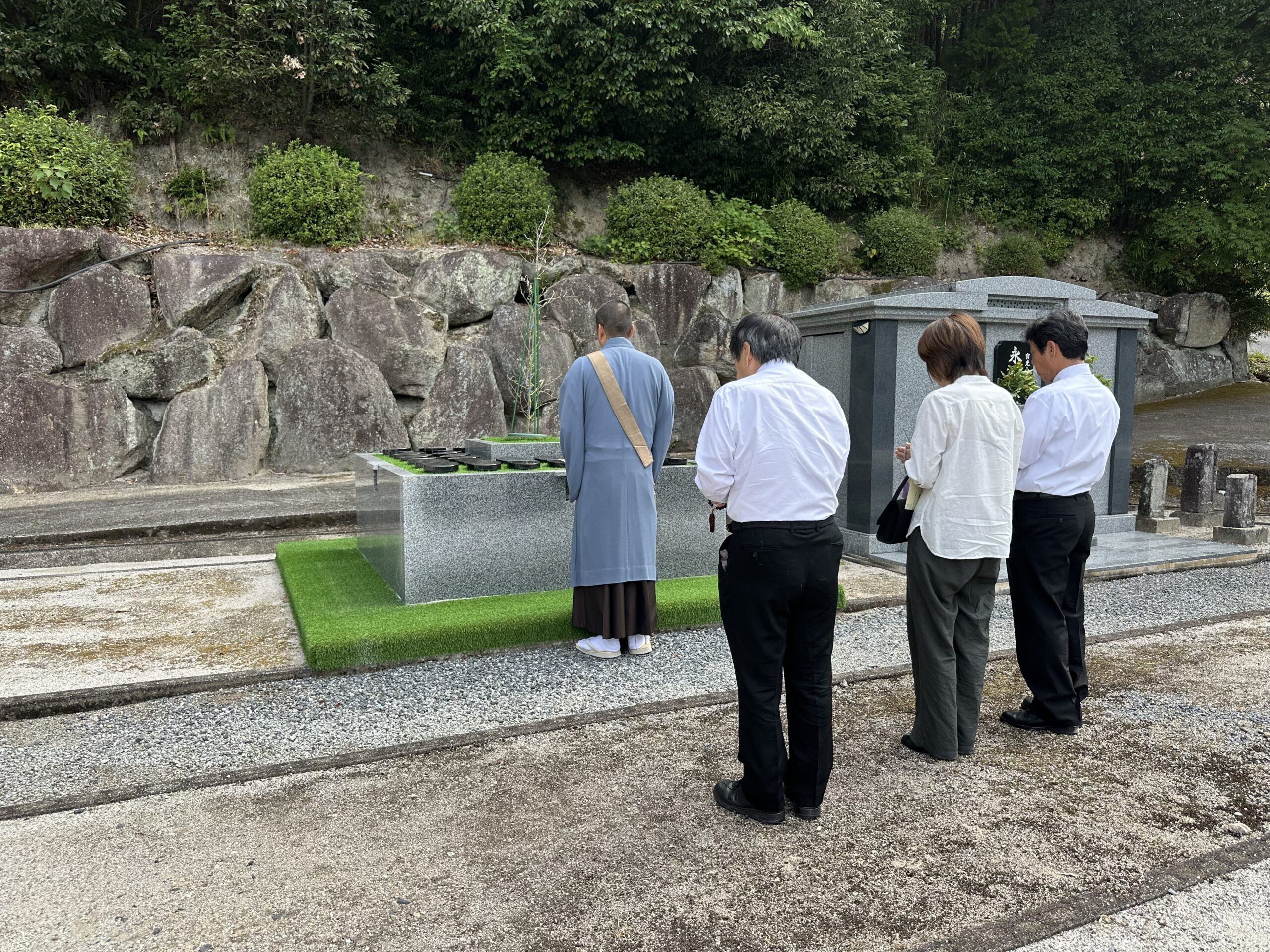 欽明寺樹木葬墓前で住職が読経を行いご遺族様が合掌される法要の様子